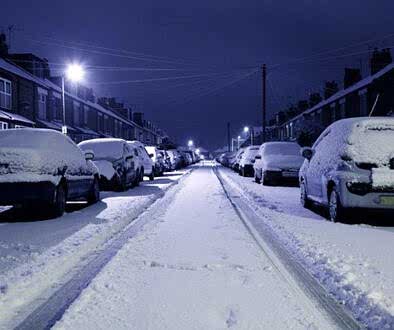 Snow covered road at night photo