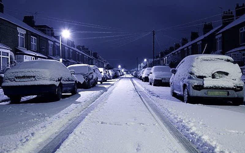 Snow covered road at night photo